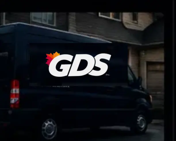 A GDS branded service van parked outside a building in the evening