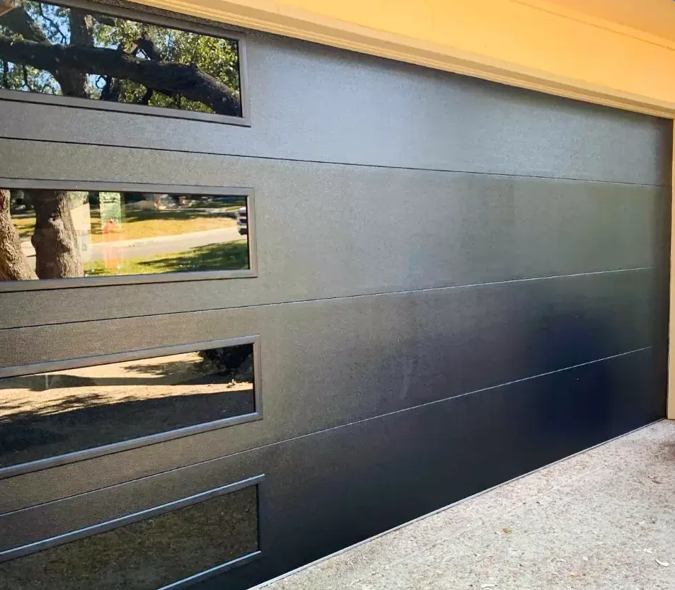 Black modern flush garage door with a column of windows installed in Oakridge, London